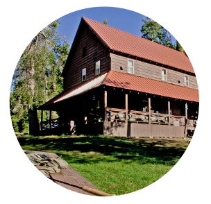 Lassen Lodging lodge on a sunny day with green grass and blue skies.