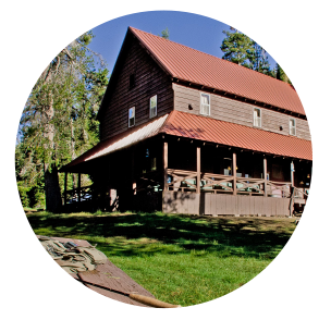Lassen Lodging lodge on a sunny day with green grass and blue skies.